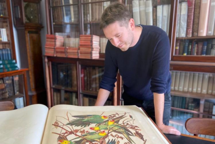 Exhibition project manager Adam Bayfield studies The Birds of America